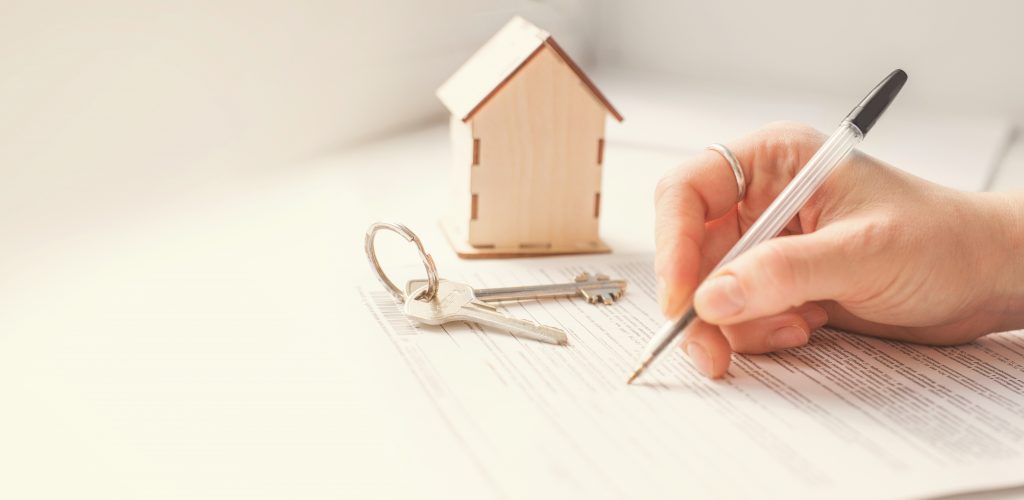 mortgage and housing rent. Keys, house and hand that signs documents. free space for text